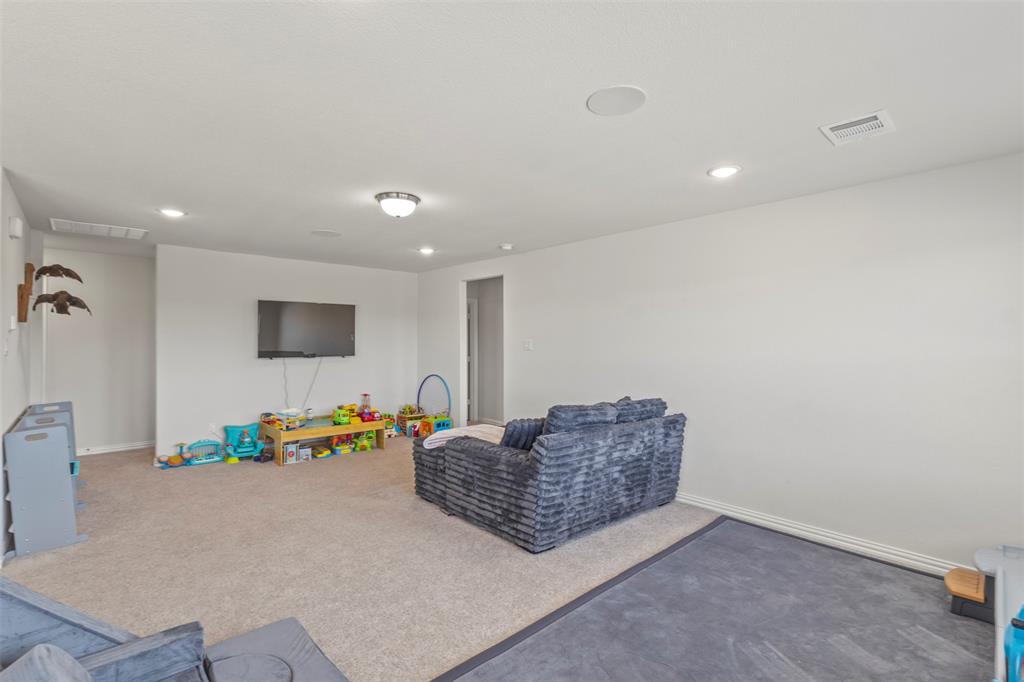 551 Ruthye Lane Pilot Point, TX 76258 - Photo 22 of 40 a living room with furniture and a flat screen tv