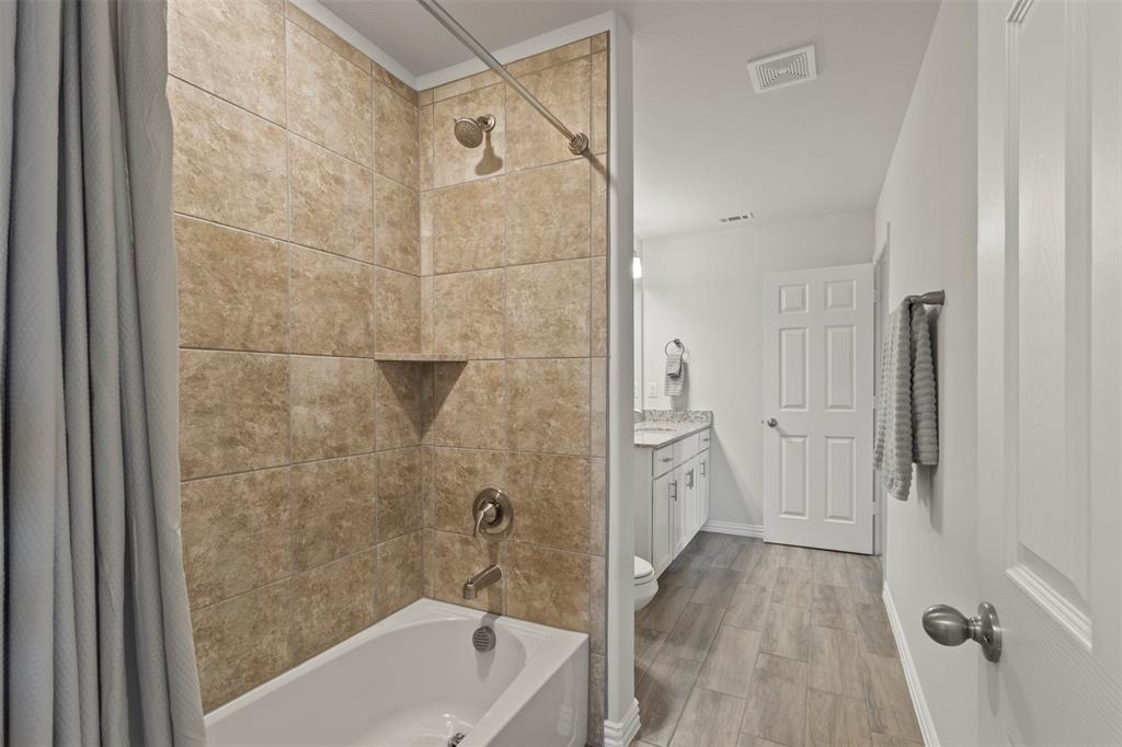 551 Ruthye Lane Pilot Point, TX 76258 - Photo 28 of 40 a bathroom with a bathtub and a shower