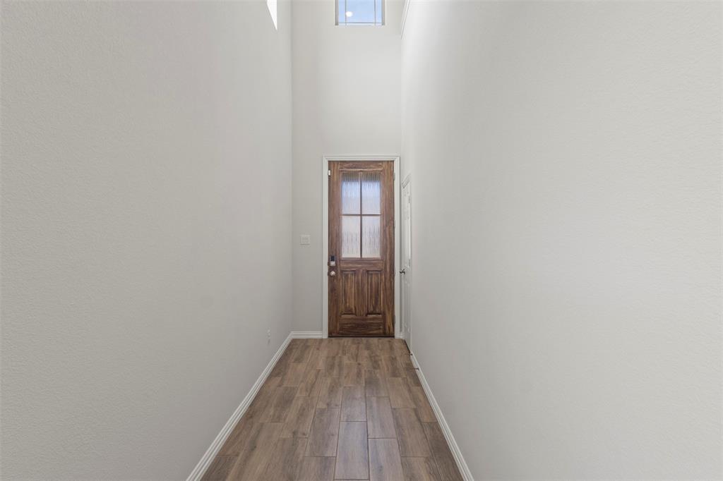 551 Ruthye Lane Pilot Point, TX 76258 - Photo 5 of 40 a view of a hallway with wooden floor