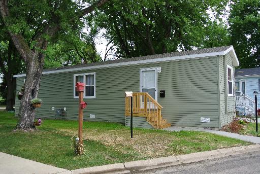 265 Parkwood Road Elgin, IL 60123 - Photo 1 of 1 a backyard of a house with potted plants and large tree