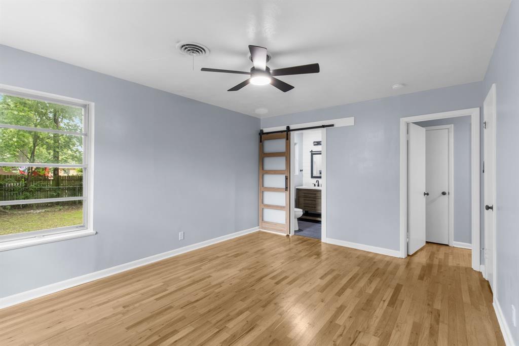 1818 Belden Street Sherman, TX 75092 - Photo 19 of 28 a view of an empty room with a window and wooden floor