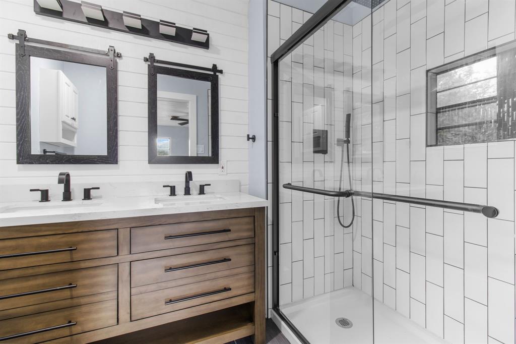 1818 Belden Street Sherman, TX 75092 - Photo 20 of 28 a bathroom with a granite countertop sink mirror and