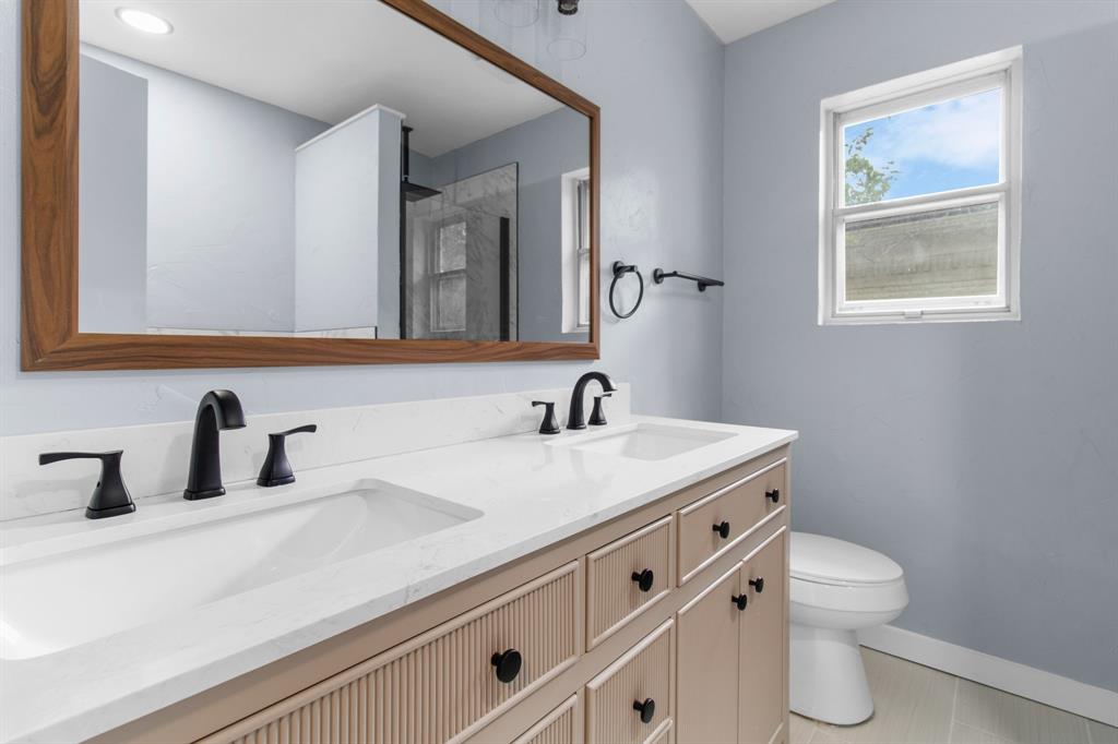 1818 Belden Street Sherman, TX 75092 - Photo 23 of 28 a bathroom with a toilet sink and mirror