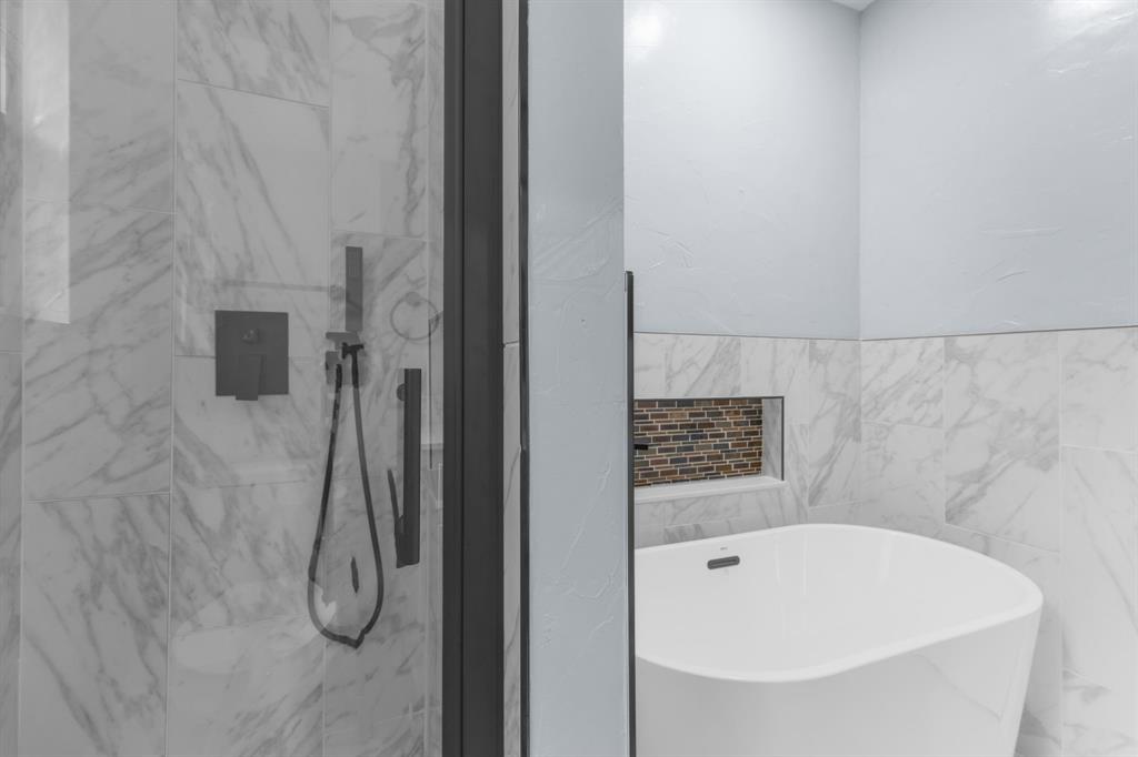 1818 Belden Street Sherman, TX 75092 - Photo 24 of 28 a bathroom with a bathtub and shower