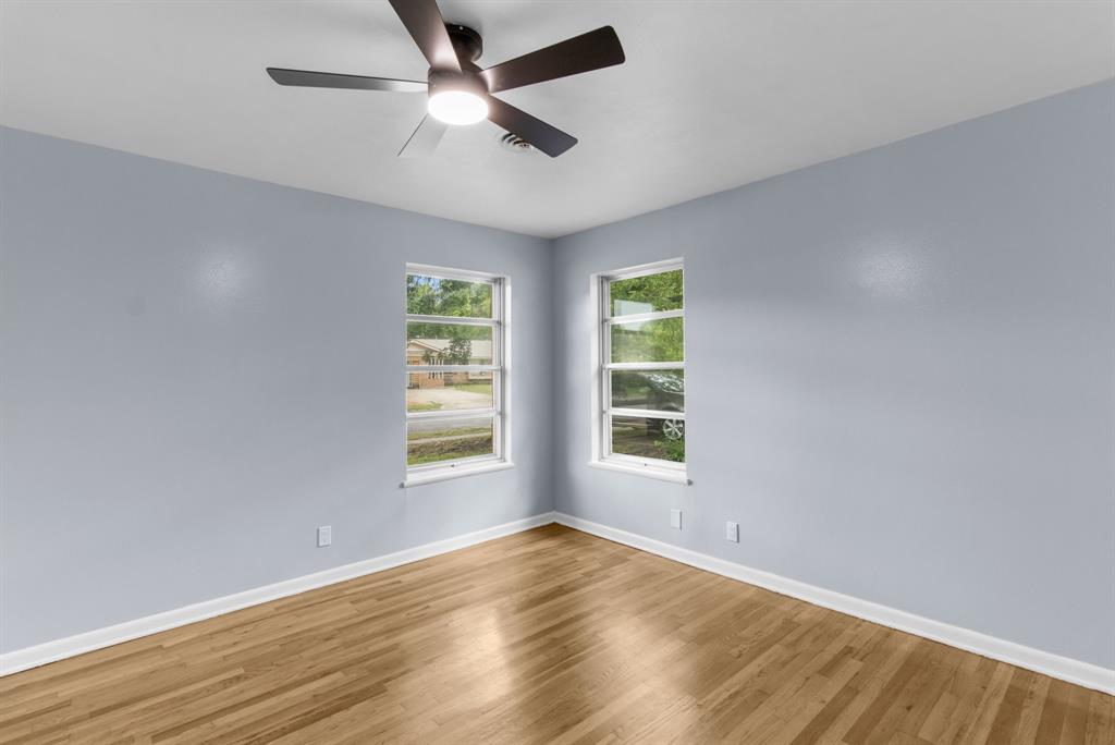 1818 Belden Street Sherman, TX 75092 - Photo 26 of 28 an empty room with wooden floor fan and windows