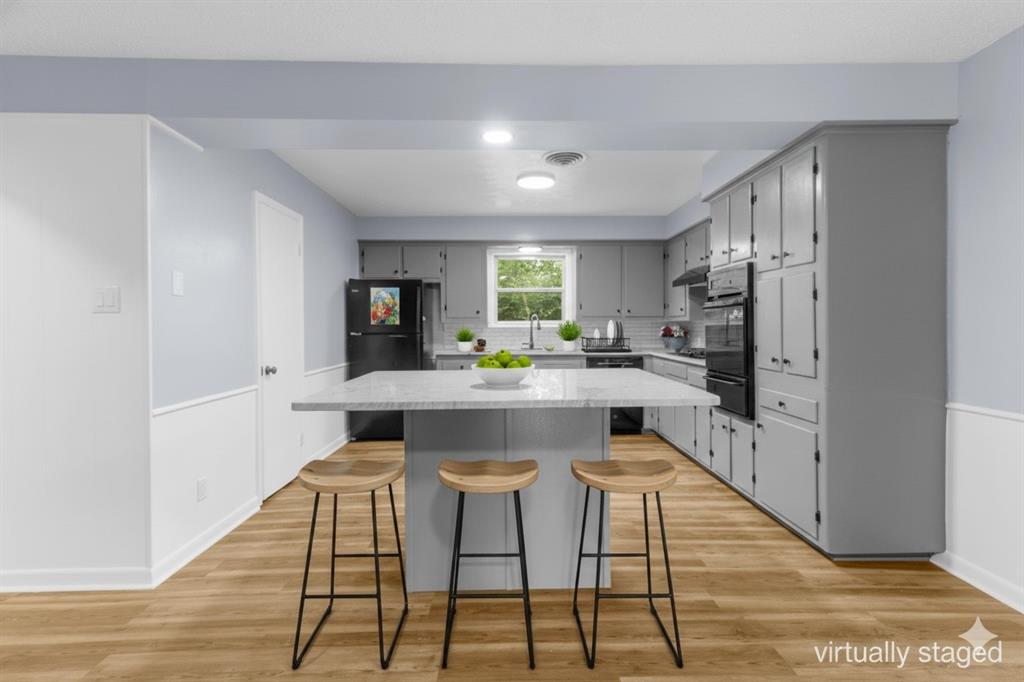 1818 Belden Street Sherman, TX 75092 - Photo 4 of 28 a kitchen with stainless steel appliances kitchen island granite countertop a refrigerator and a stove top oven