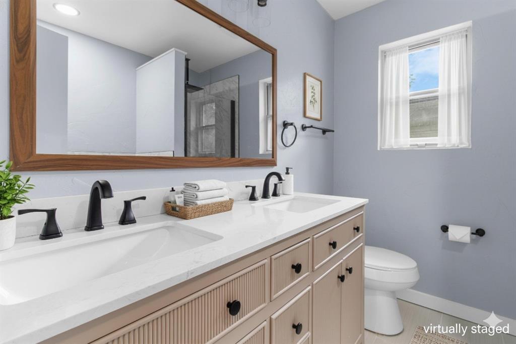 1818 Belden Street Sherman, TX 75092 - Photo 7 of 28 a bathroom with a sink a toilet and a mirror