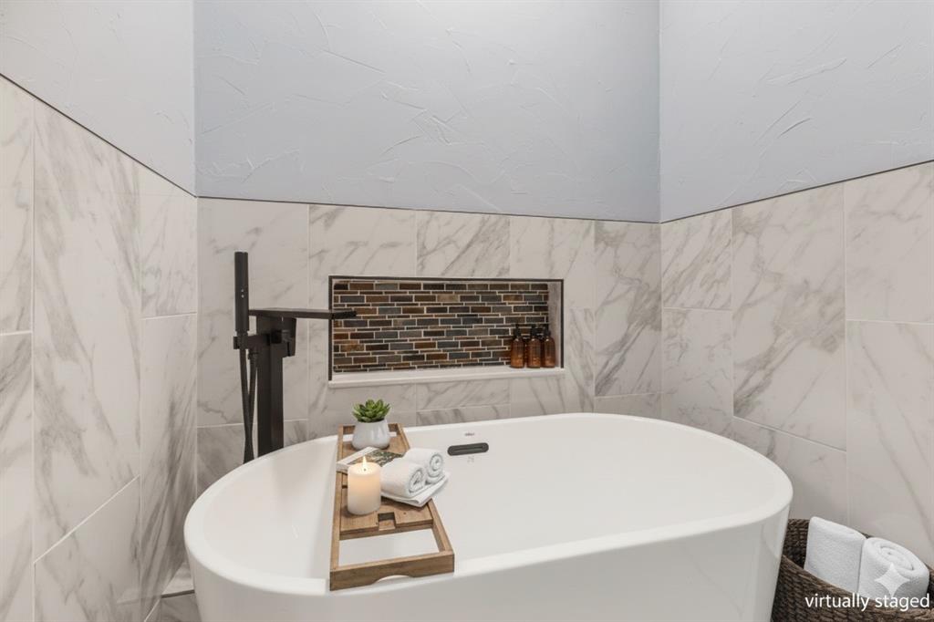 1818 Belden Street Sherman, TX 75092 - Photo 9 of 28 a bathroom with a white bath tub and a shower curtain