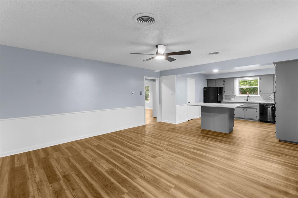 1818 Belden Street Sherman, TX 75092 - Photo 10 of 28 a view of an empty room with a kitchen and a sink
