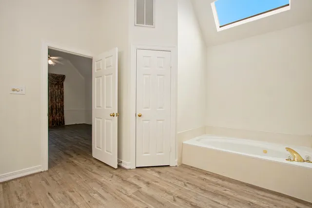 a view of a bathtub in a hallway