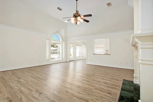 wooden floor in an empty room with a window