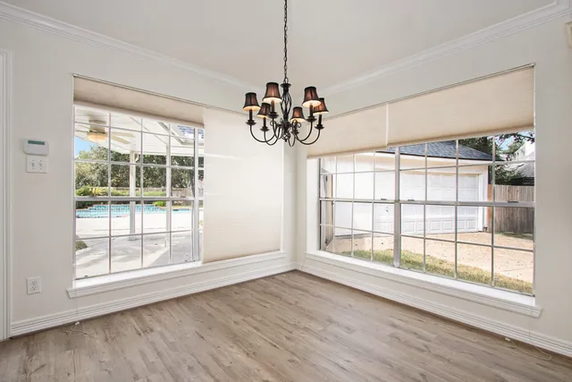 a view of wooden floor and a chandelier