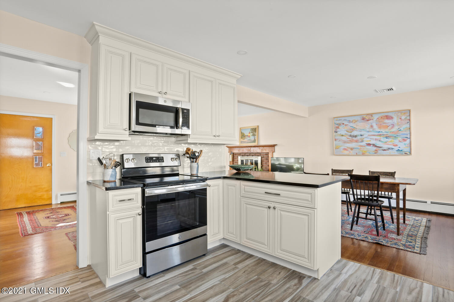 29 Thorn Hill Road Riverside, CT 06878 - Photo 7 of 24 a kitchen with stainless steel appliances granite countertop a stove top oven a sink and white cabinets