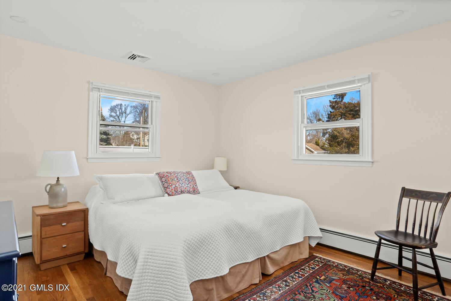 29 Thorn Hill Road Riverside, CT 06878 - Photo 9 of 24 a bedroom with a bed and a lamp on dresser