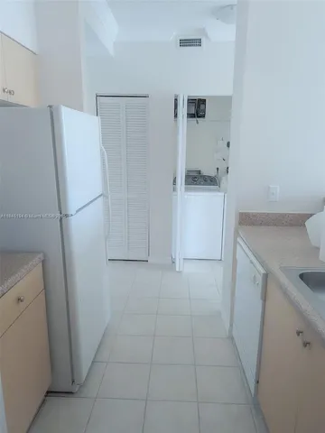a utility room with cabinets washer and dryer