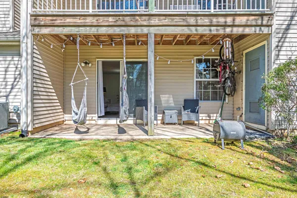 a view of a house with backyard and sitting area