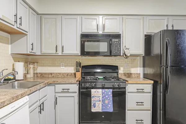a kitchen with cabinets appliances and a sink