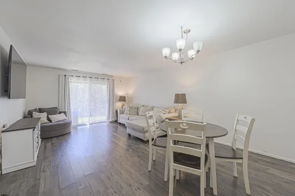 a view of a dining room with furniture wooden floor and chandelier