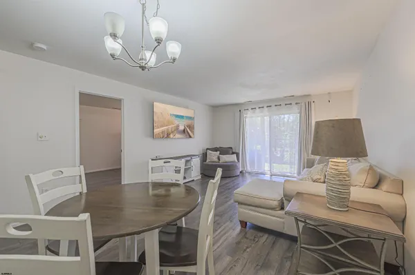 a view of a dining room with furniture and wooden floor
