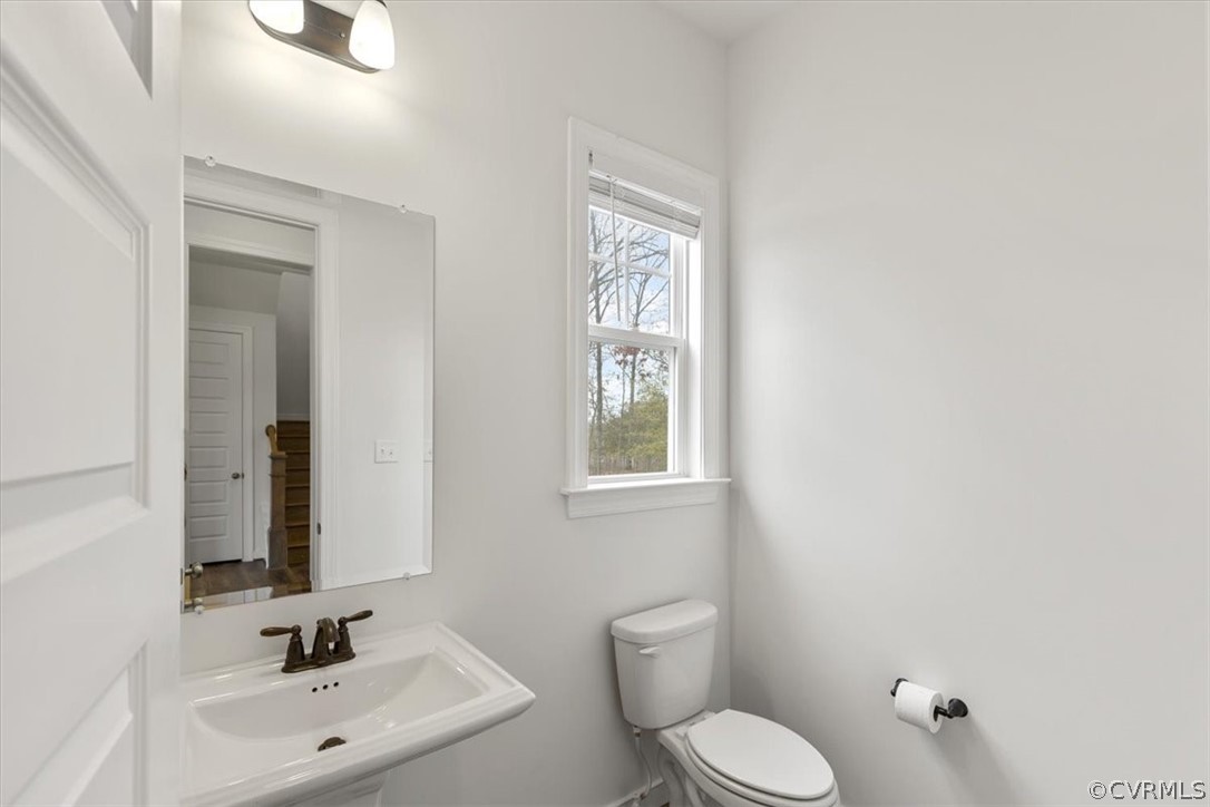 2514 Channelmark Place Chester, VA 23836 - Photo 12 of 50 a bathroom with a toilet a sink and mirror