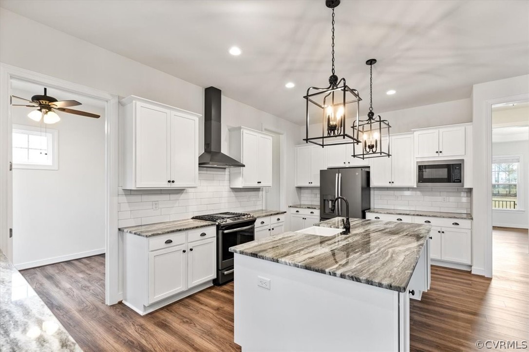 2514 Channelmark Place Chester, VA 23836 - Photo 22 of 50 a kitchen with stainless steel appliances granite countertop a sink a stove and a wooden floor