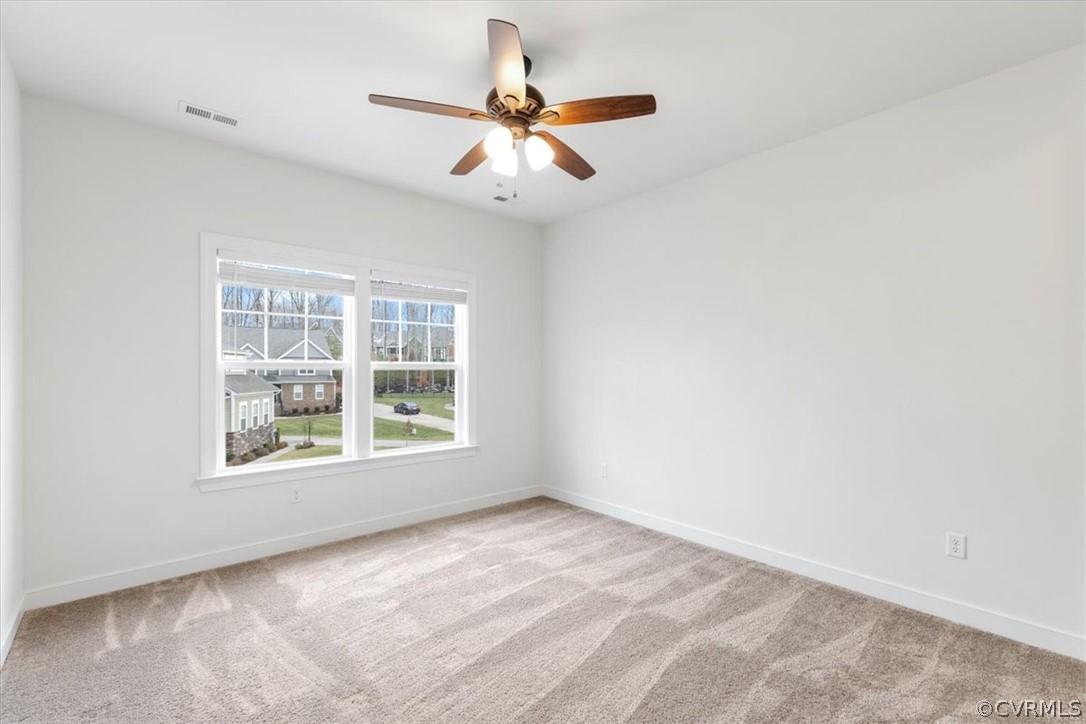 2514 Channelmark Place Chester, VA 23836 - Photo 34 of 50 an empty room with a window and a ceiling fan