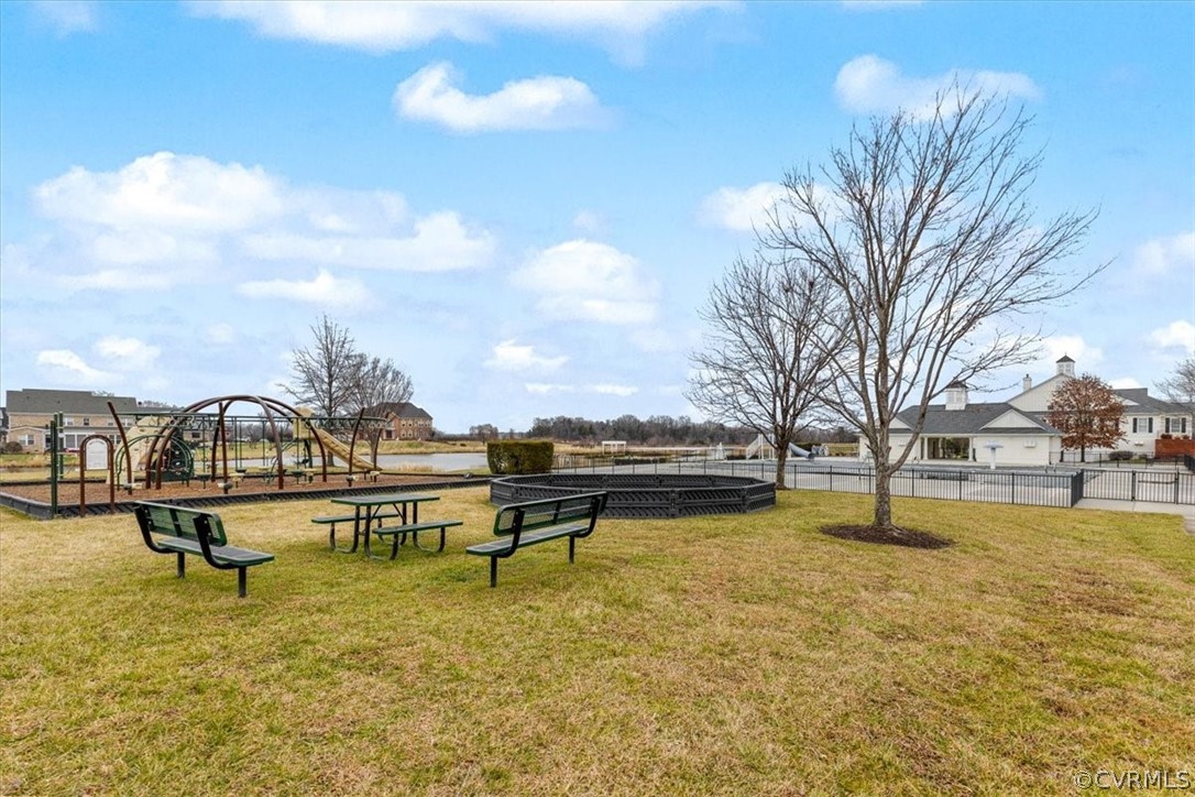2514 Channelmark Place Chester, VA 23836 - Photo 49 of 50 a view of a lake with a bench and trees around