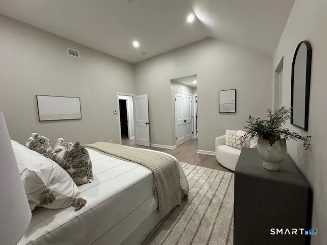 a bedroom with bed and a couch