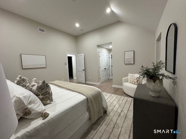 74 Soundview Avenue Fairfield, CT 06825 - Photo 15 of 32 a bedroom with bed and a couch