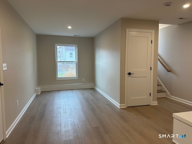 74 Soundview Avenue Fairfield, CT 06825 - Photo 24 of 32 a view of an empty room with wooden floor and a window