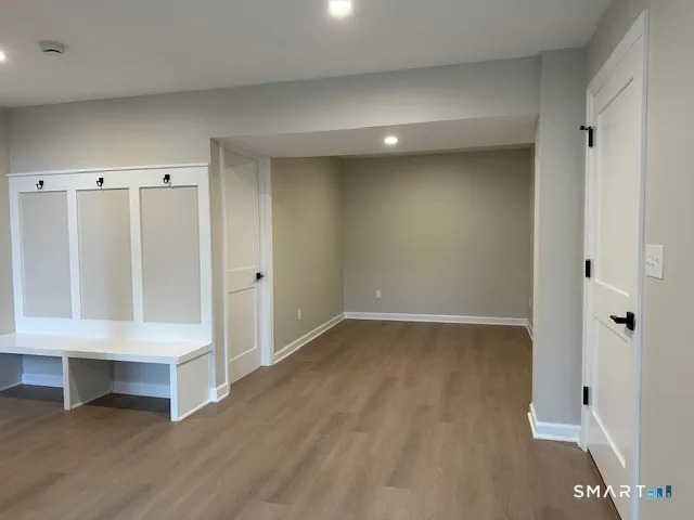 a view of an empty room and a kitchen