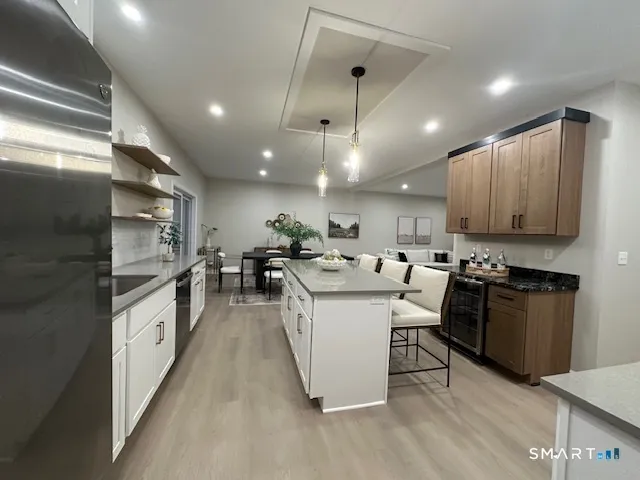 a large white kitchen with lots of counter space a sink and appliances
