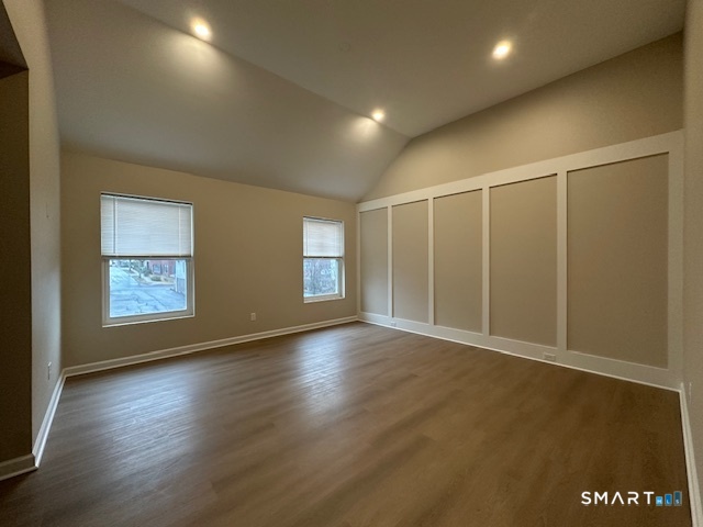 74 Soundview Avenue Fairfield, CT 06825 - Photo 32 of 32 an empty room with wooden floor and windows