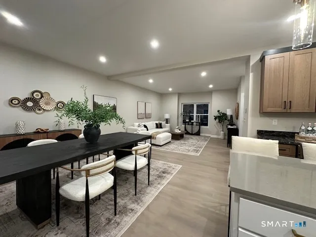 a living room with furniture a rug and a kitchen view