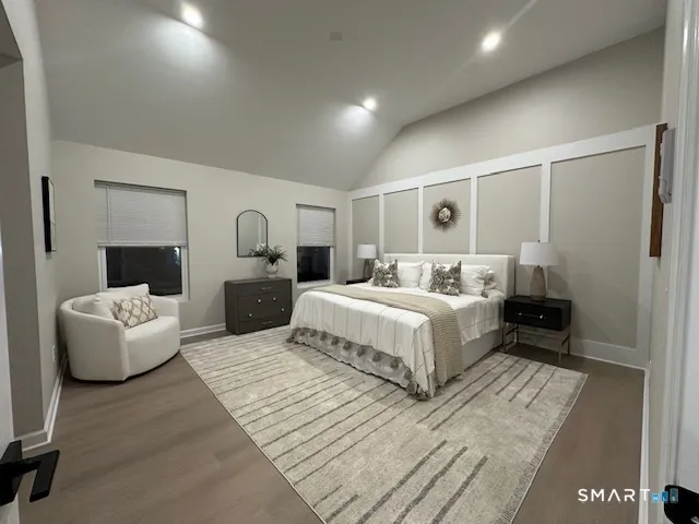 a bedroom with a large bed and a couch