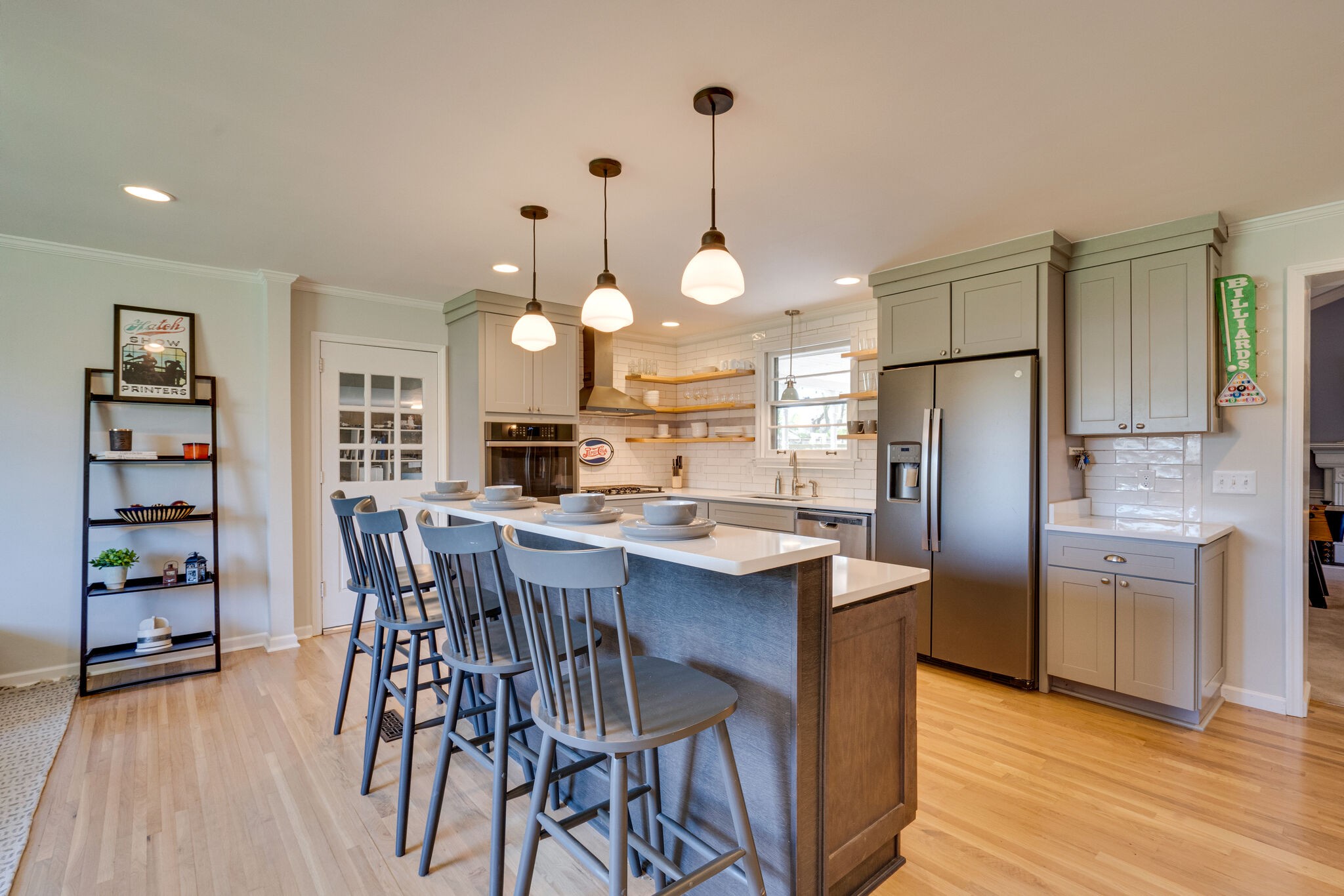 338 Stable Road Franklin, TN 37069 - Photo 5 of 26 a kitchen with stainless steel appliances a dining table chairs refrigerator and cabinets
