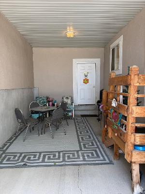 641 East Greystone Way Tooele, UT 84074 - Photo 20 of 30 Covered patio space featuring a corrugated metal ceiling and concrete flooring