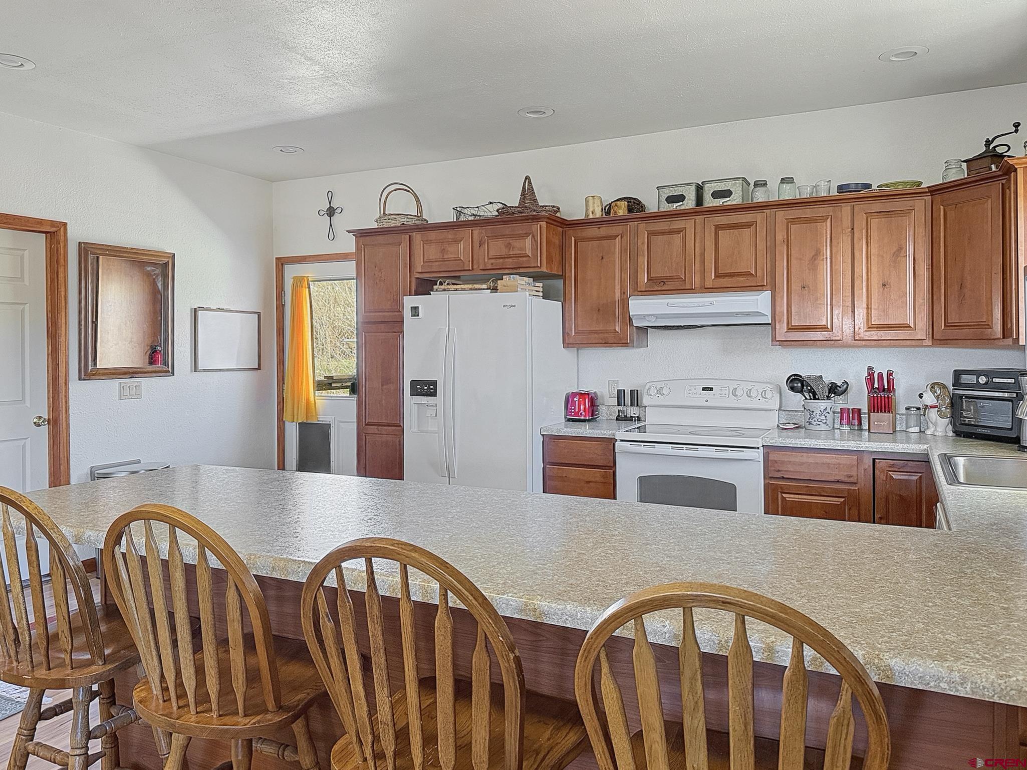 240 F Street Crawford, CO 81415 - Photo 12 of 45 a kitchen with furniture a refrigerator and cabinets