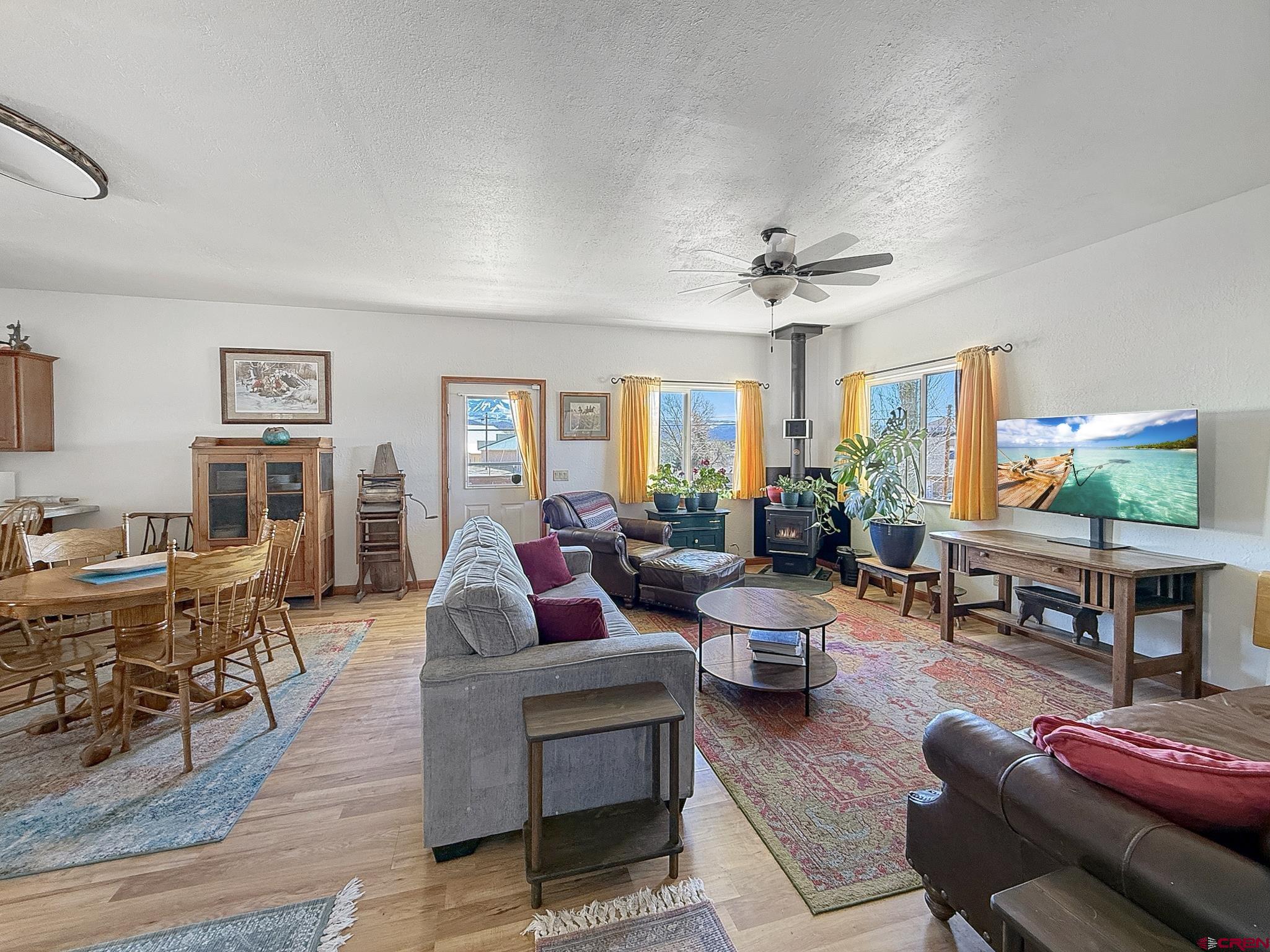 240 F Street Crawford, CO 81415 - Photo 20 of 45 a living room with furniture a fireplace and a window