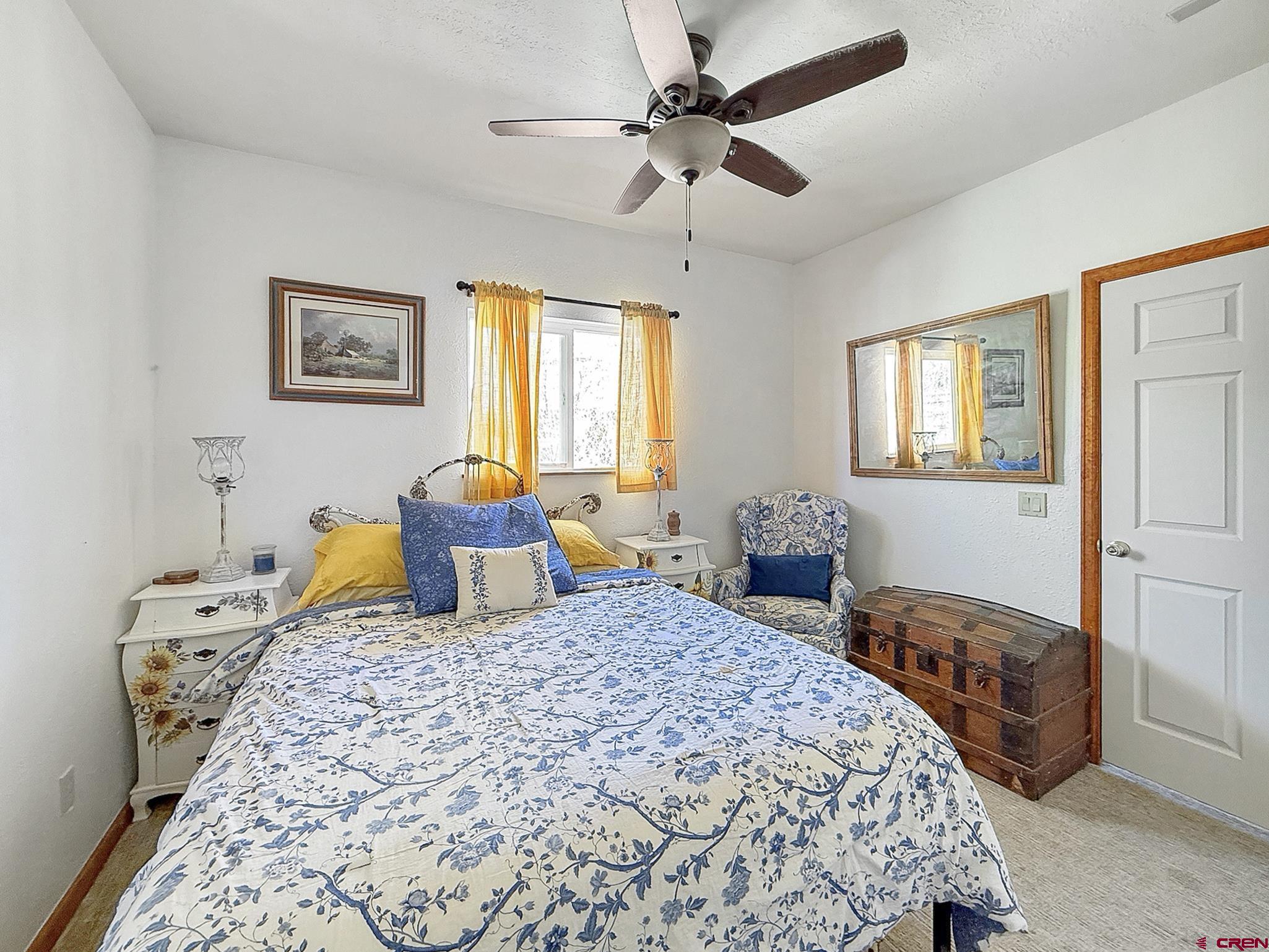 240 F Street Crawford, CO 81415 - Photo 23 of 45 a bedroom with two beds and a chandelier