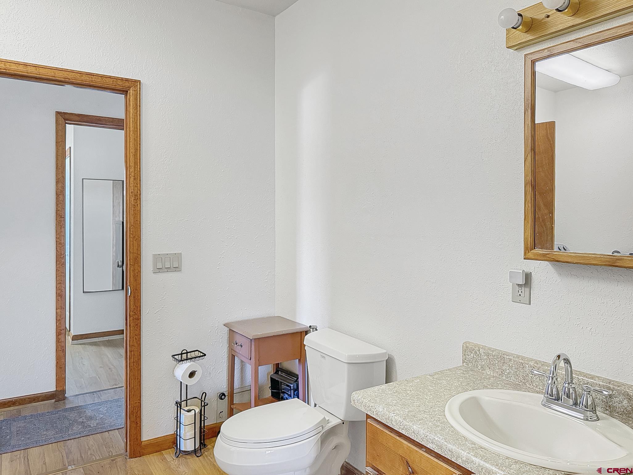 240 F Street Crawford, CO 81415 - Photo 28 of 45 a bathroom with a toilet a sink and a mirror