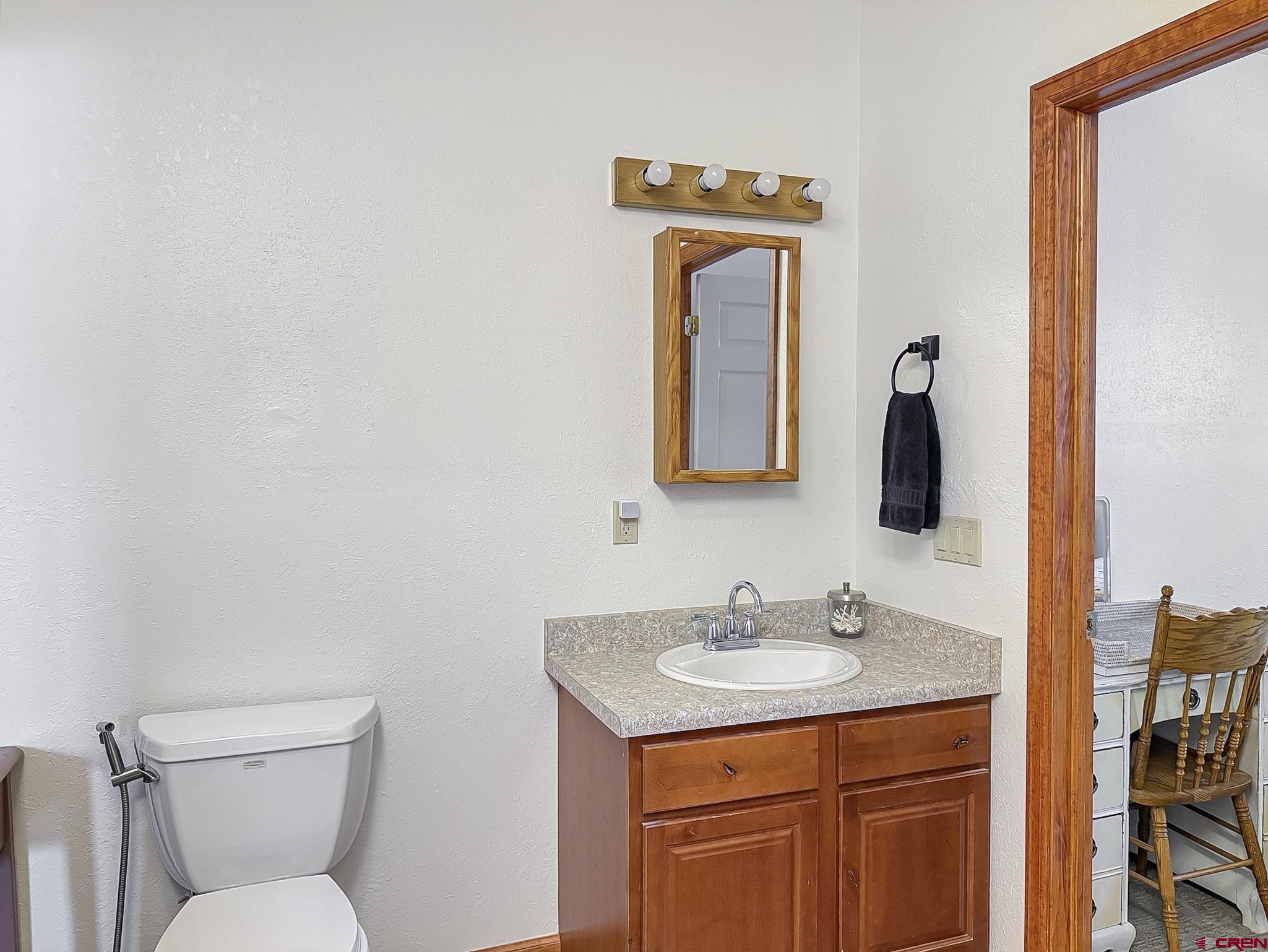 240 F Street Crawford, CO 81415 - Photo 30 of 45 a bathroom with a toilet sink and mirror