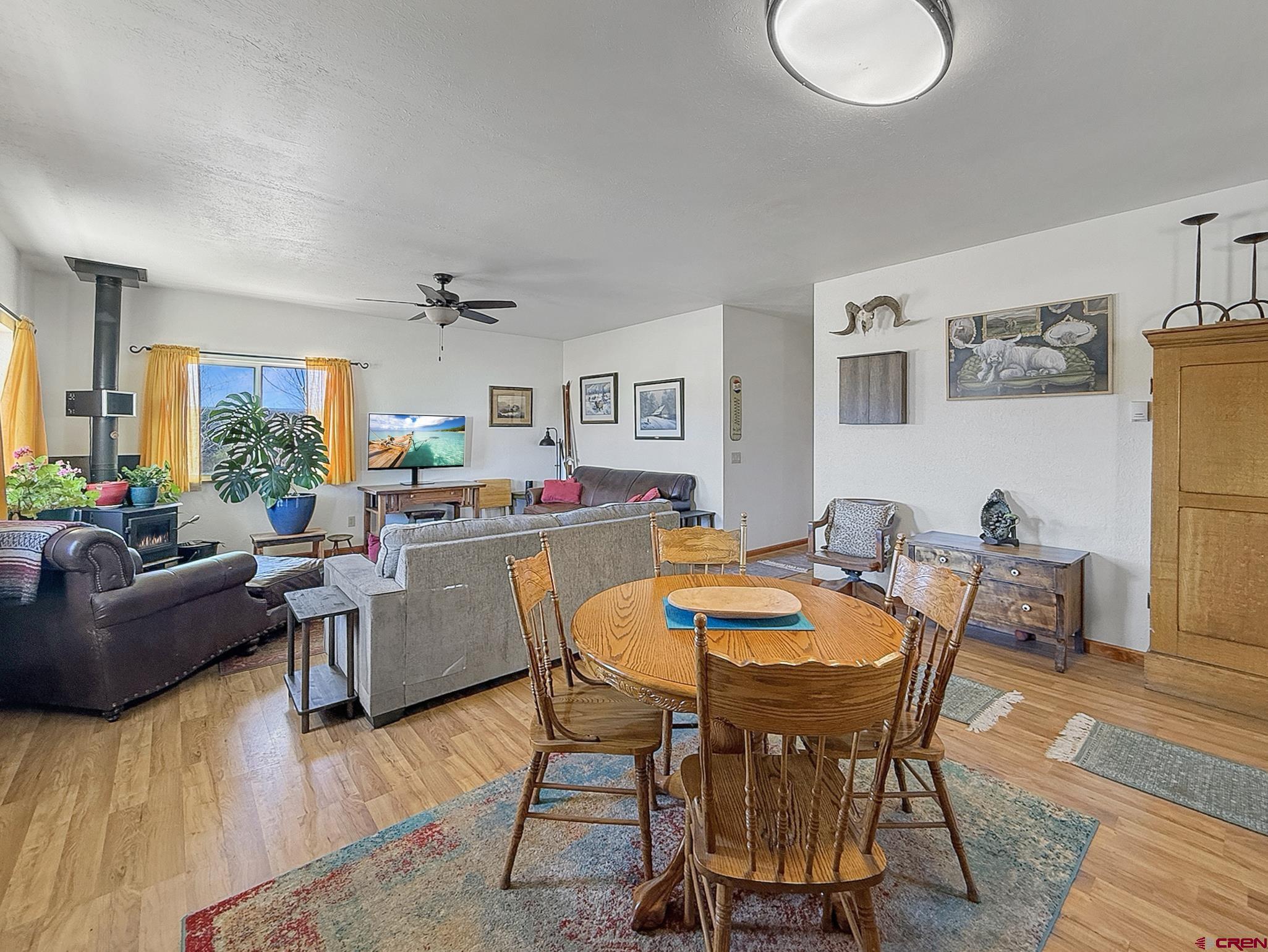 240 F Street Crawford, CO 81415 - Photo 3 of 45 a living room with furniture and a dining table with wooden floor