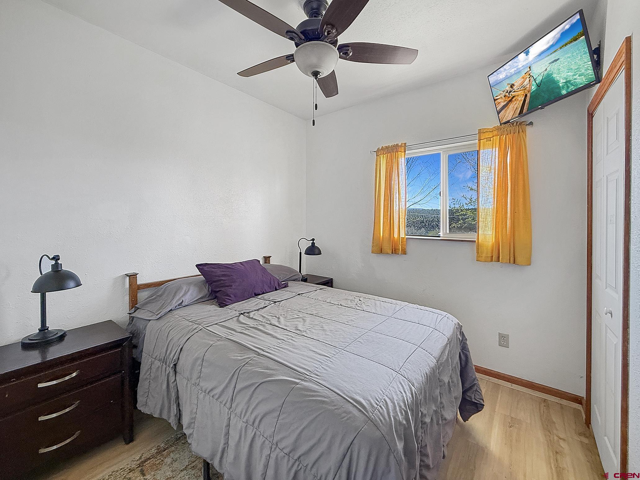 240 F Street Crawford, CO 81415 - Photo 31 of 45 a bedroom with a bed and wooden floor
