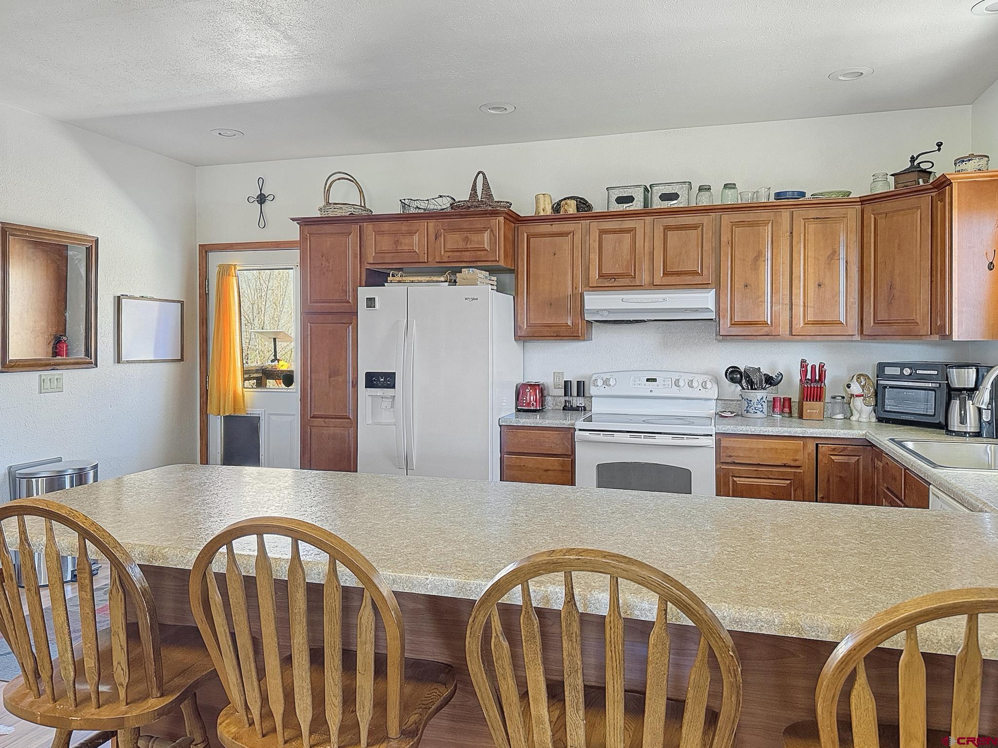 240 F Street Crawford, CO 81415 - Photo 8 of 45 a kitchen with stainless steel appliances granite countertop a stove a sink dishwasher and cabinets with wooden floor