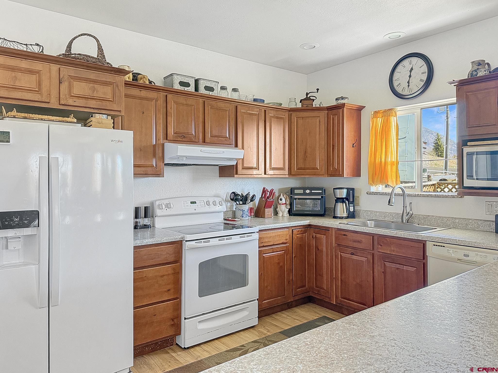 240 F Street Crawford, CO 81415 - Photo 9 of 45 a kitchen with cabinets a stainless steel appliances and white cabinets