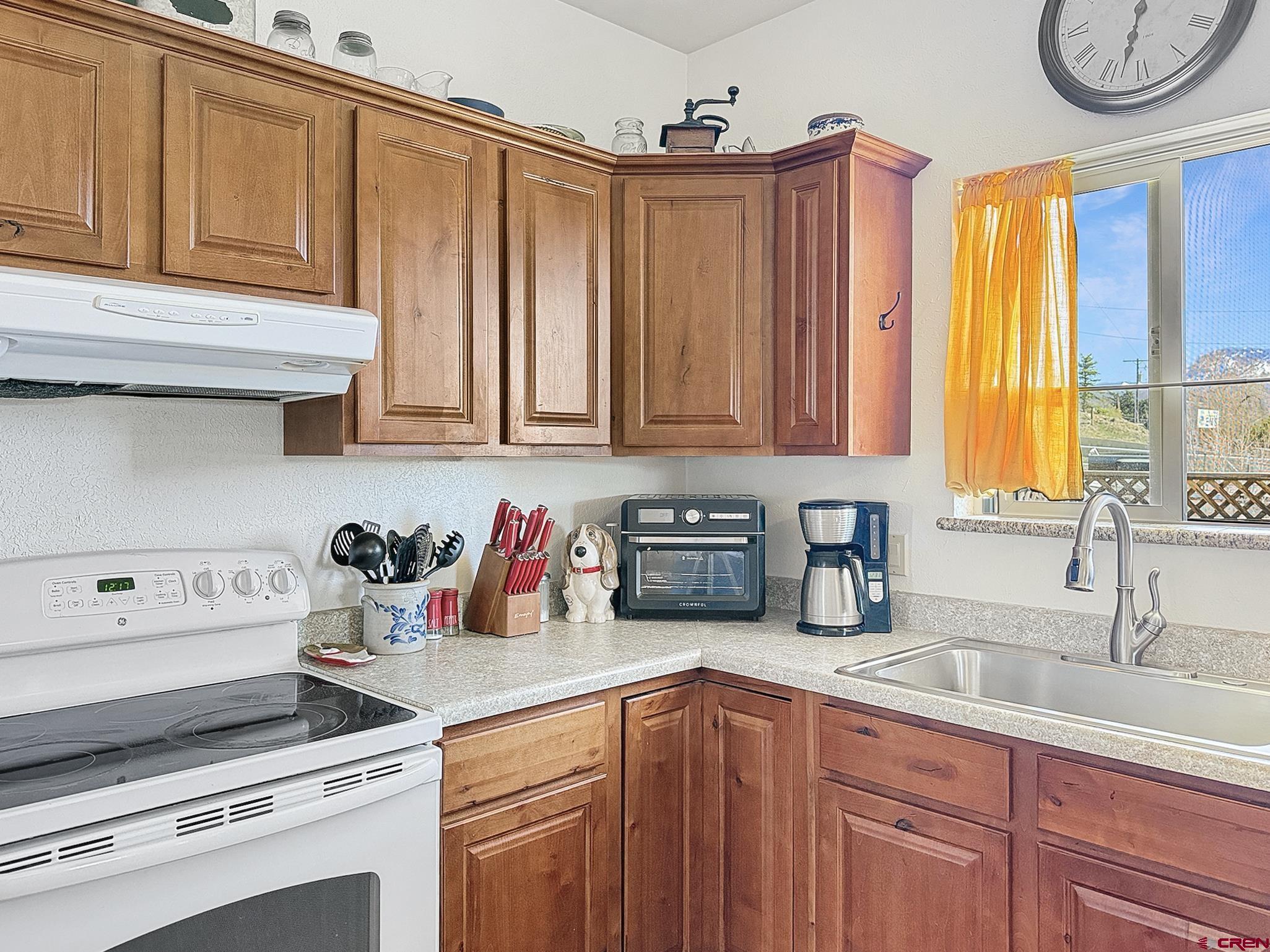 240 F Street Crawford, CO 81415 - Photo 10 of 45 a kitchen with stainless steel appliances granite countertop a sink a stove cabinets and a counter space