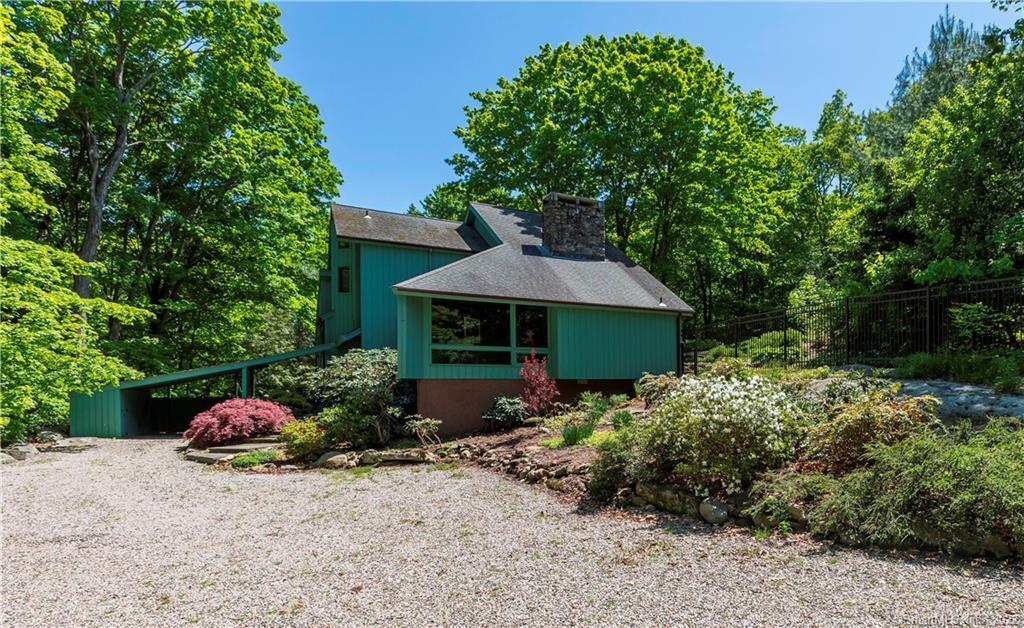 163 Whipstick Road Wilton, CT 06897 - Photo 1 of 1 an outdoor space with plants and umbrella
