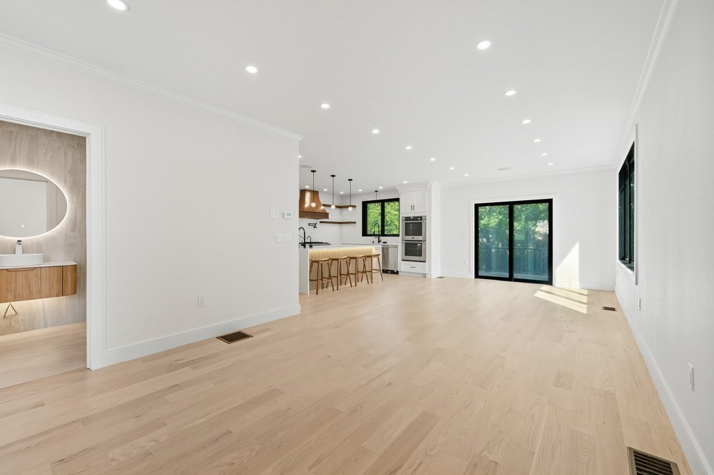 863 Main Street Reading, MA 01867 - Photo 11 of 42 a view of an empty room with a kitchen