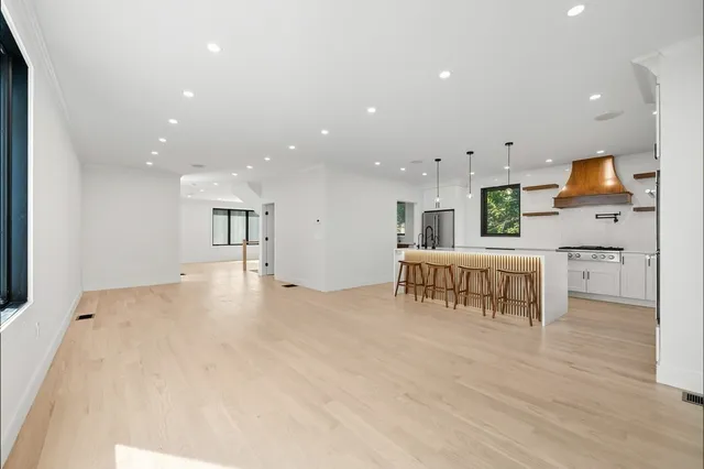 a kitchen with stainless steel appliances kitchen island sink refrigerator and microwave